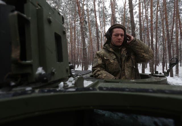 <p>A Ukrainian tank crew member of the 21st Mechanized Brigade stands in the hatch of a snow covered German made Leopard 2A5 battle tank near the front line in an undisclosed location in Donetsk region</p>
