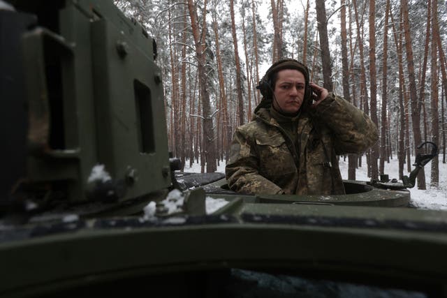 <p>A Ukrainian tank crew member of the 21st Mechanized Brigade stands in the hatch of a snow covered German made Leopard 2A5 battle tank near the front line in an undisclosed location in Donetsk region</p>