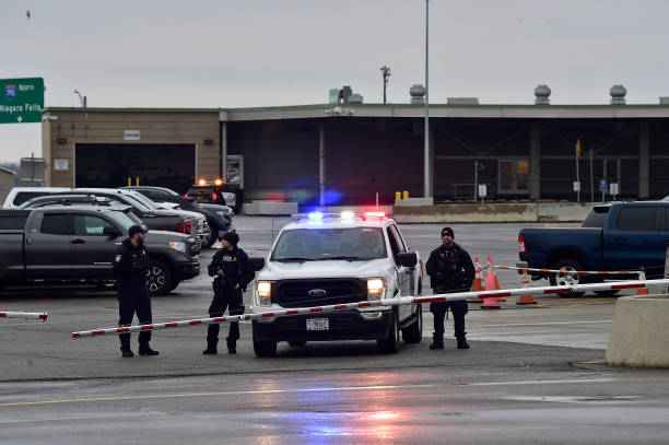 Police stand guard as the Peace Bridge, one of four major crossings into the US from Canada, is closed after a car crashed and exploded at The Rainbow Bridge on 22 November 2023