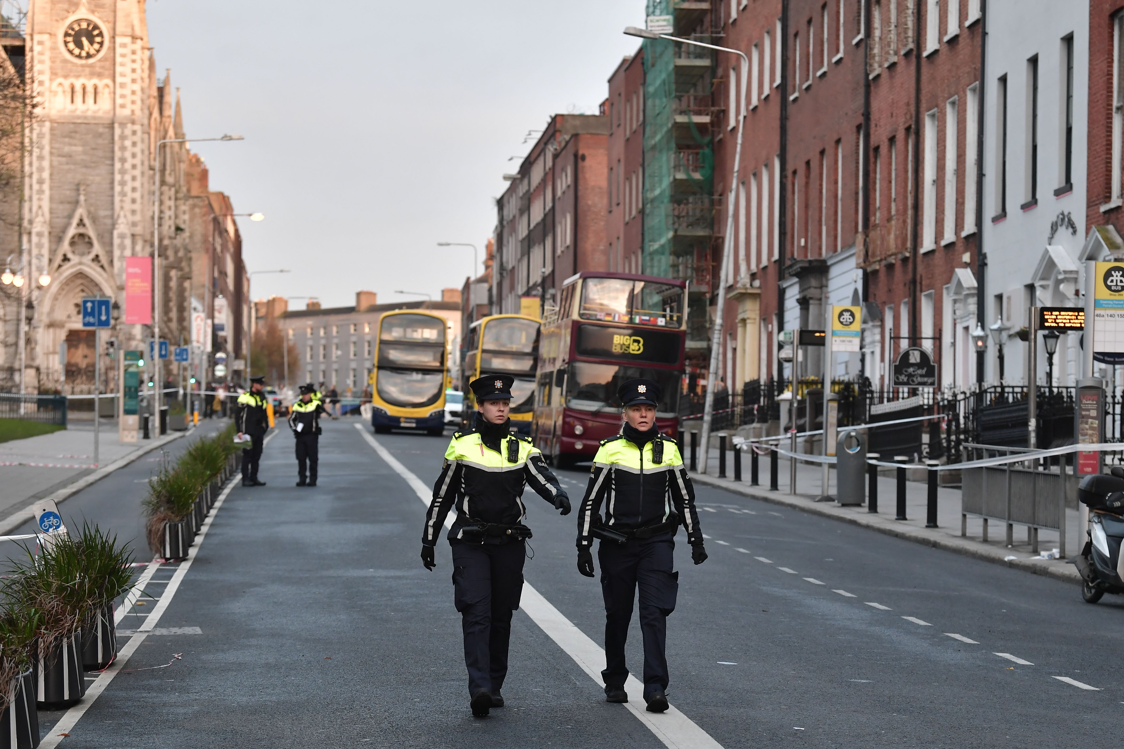 Police officers walk near the crime scene of the school stabbings in Dublin