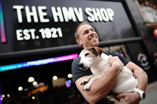 Owner of HMV, Doug Putman, with the dog Holly outside the new HMV store, which has returned to Oxford Street in London following a four-year absence (Aaron Chown/PA)