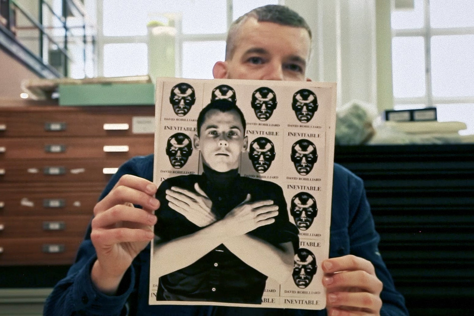 Russell Tovey holds photo of David Robilliard, who poses with prints of his poetry collection ‘Invincible'