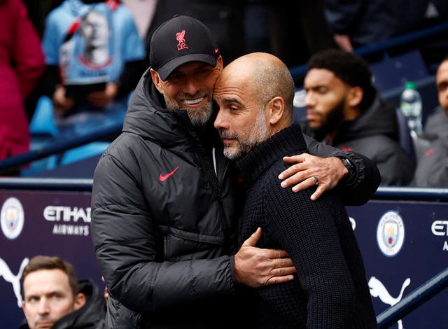 <p>Manchester City manager Pep Guardiola gets a warm welcome from his Liverpool counterpart Jurgen Klopp, who wants to make life ‘really uncomfortable’ for the champions on Saturday afternoon </p>
