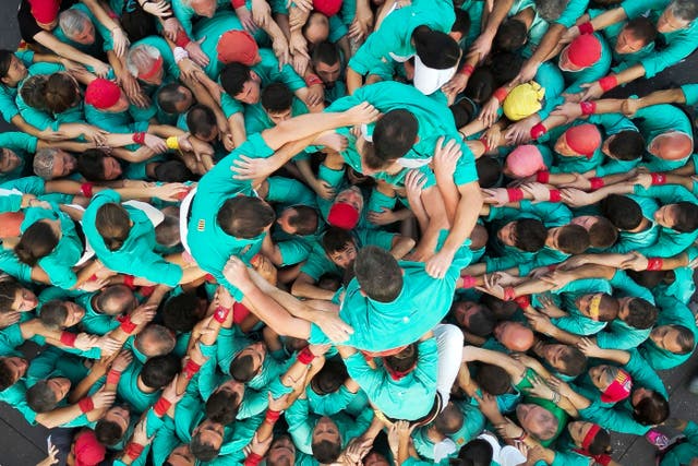 <p>Members of the “Castellers de Villafranca” Human Tower team form a “castell” during an exhibition to celebrate the 75th anniversary of their foundation at the Zocalo square in Mexico City. </p>