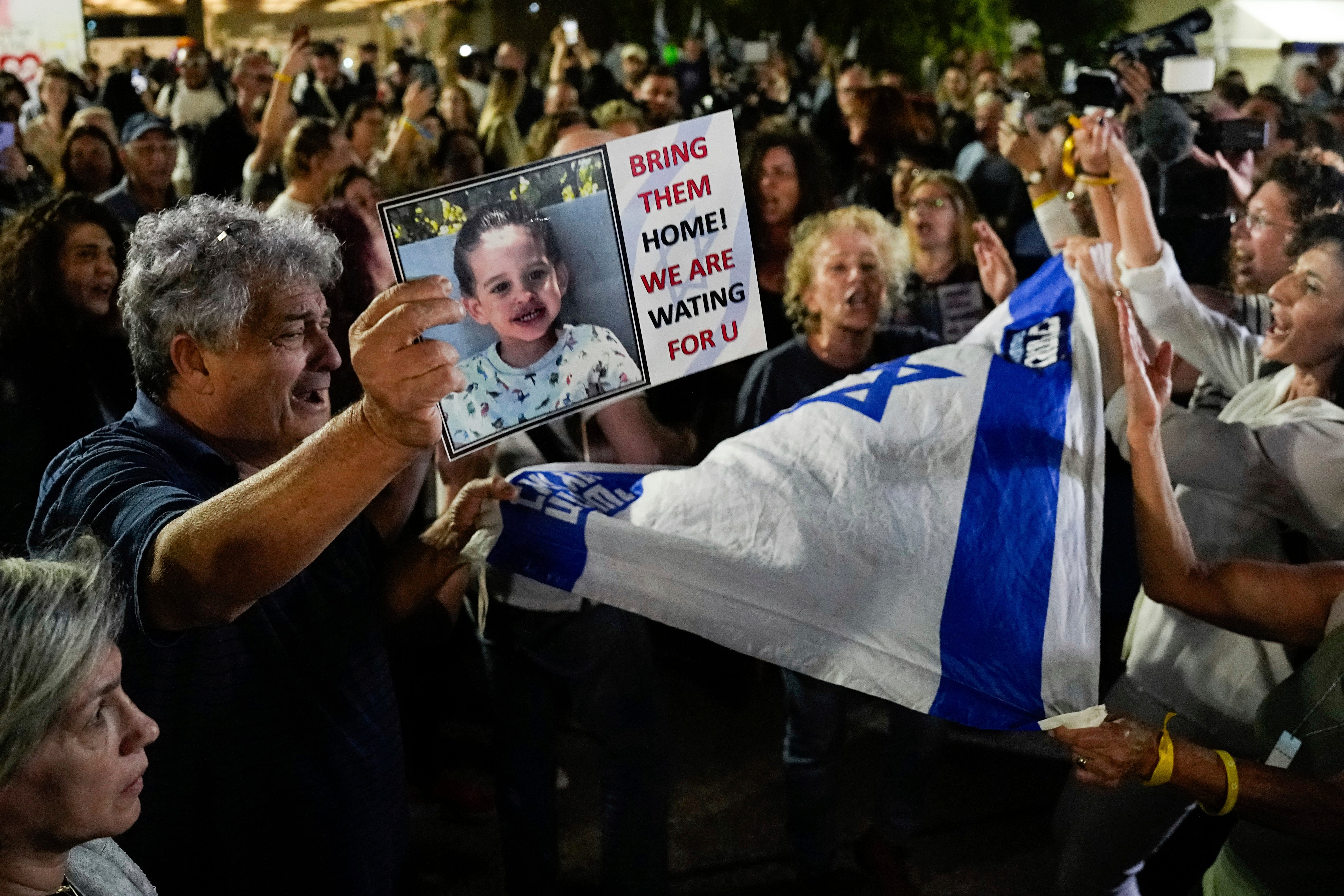 People in Tel Aviv, Israel, react as they hear the news of the release of 13 Israeli hostages held by Hamas in the Gaza Strip (Ariel Schalit/PA)