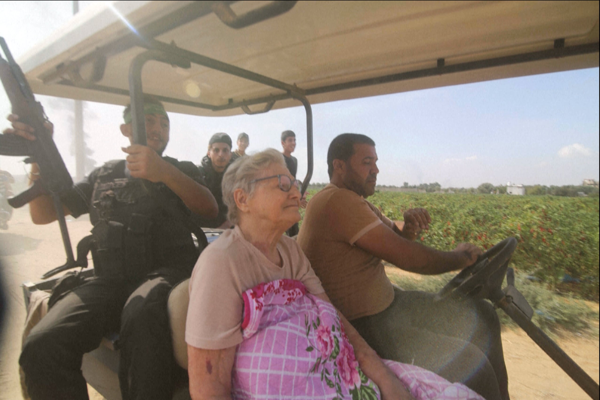 In this still image taken from video, Hamas’ militants transport Yaffa Adar, 85, an Israeli civilian kidnapped from southern Israel.