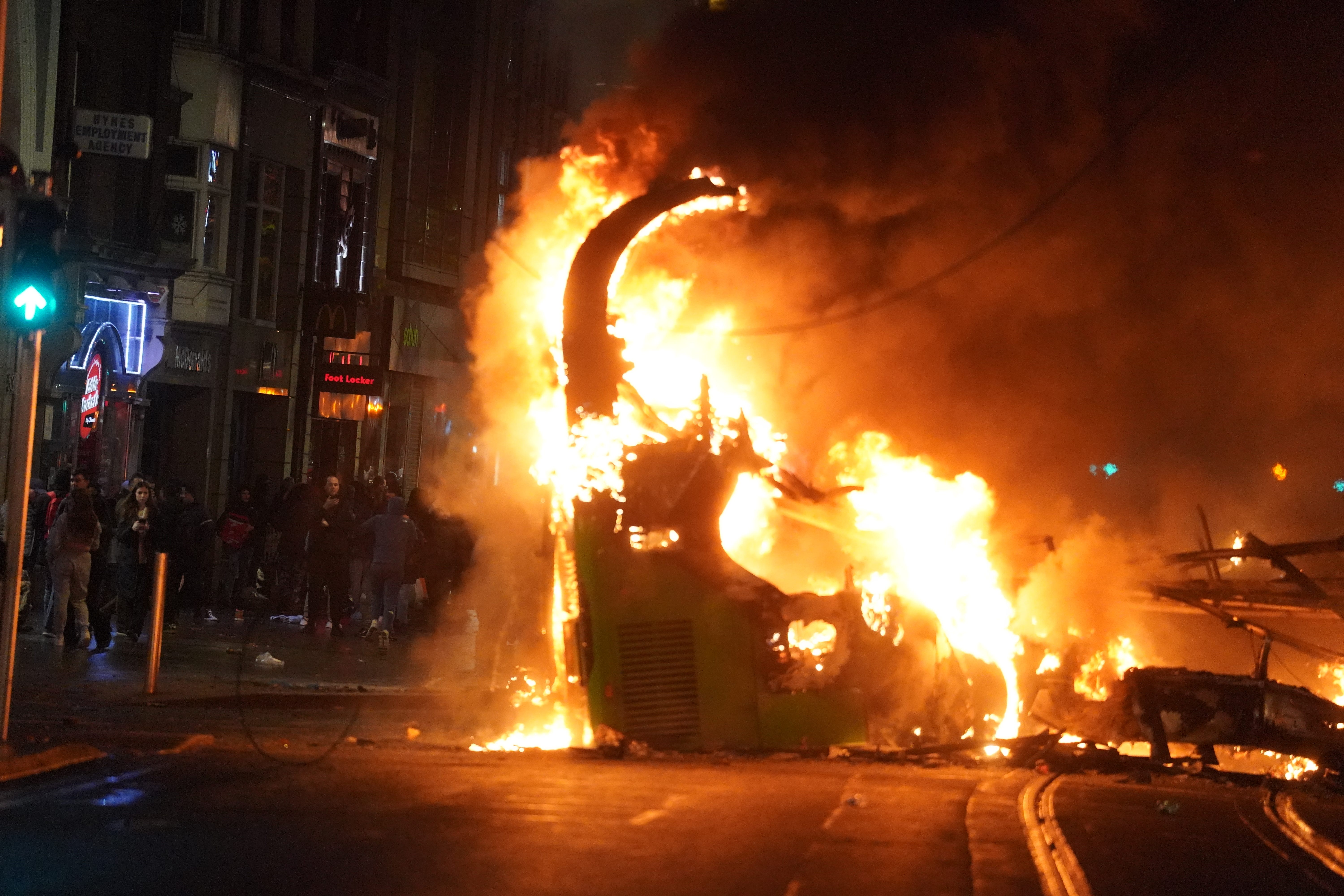 A bus on fire on O’Connell Street in Dublin city centre after violent scenes unfolded following a knife attack on Parnell Square East on Thursday