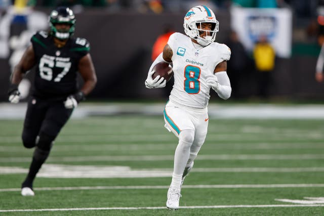 Miami Dolphins safety Jevon Holland runs an interception back for a touchdown against the New York Jets (Noah K Murray/AP)