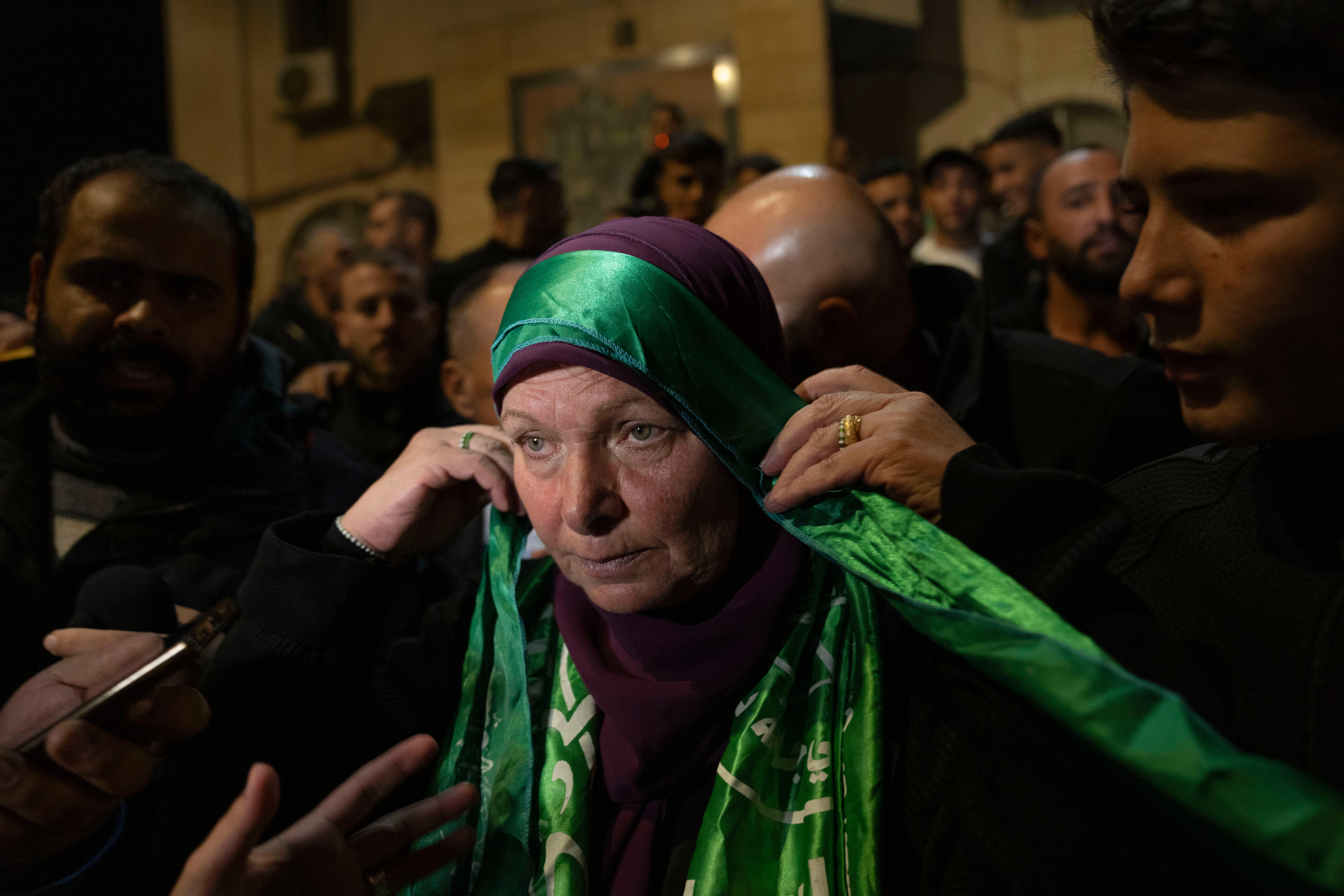 Former Palestinian female prisoner Hanna Barghouti wears a Hamas headband while she is received by supporters upon her arrival in the West Bank town of Beitunia