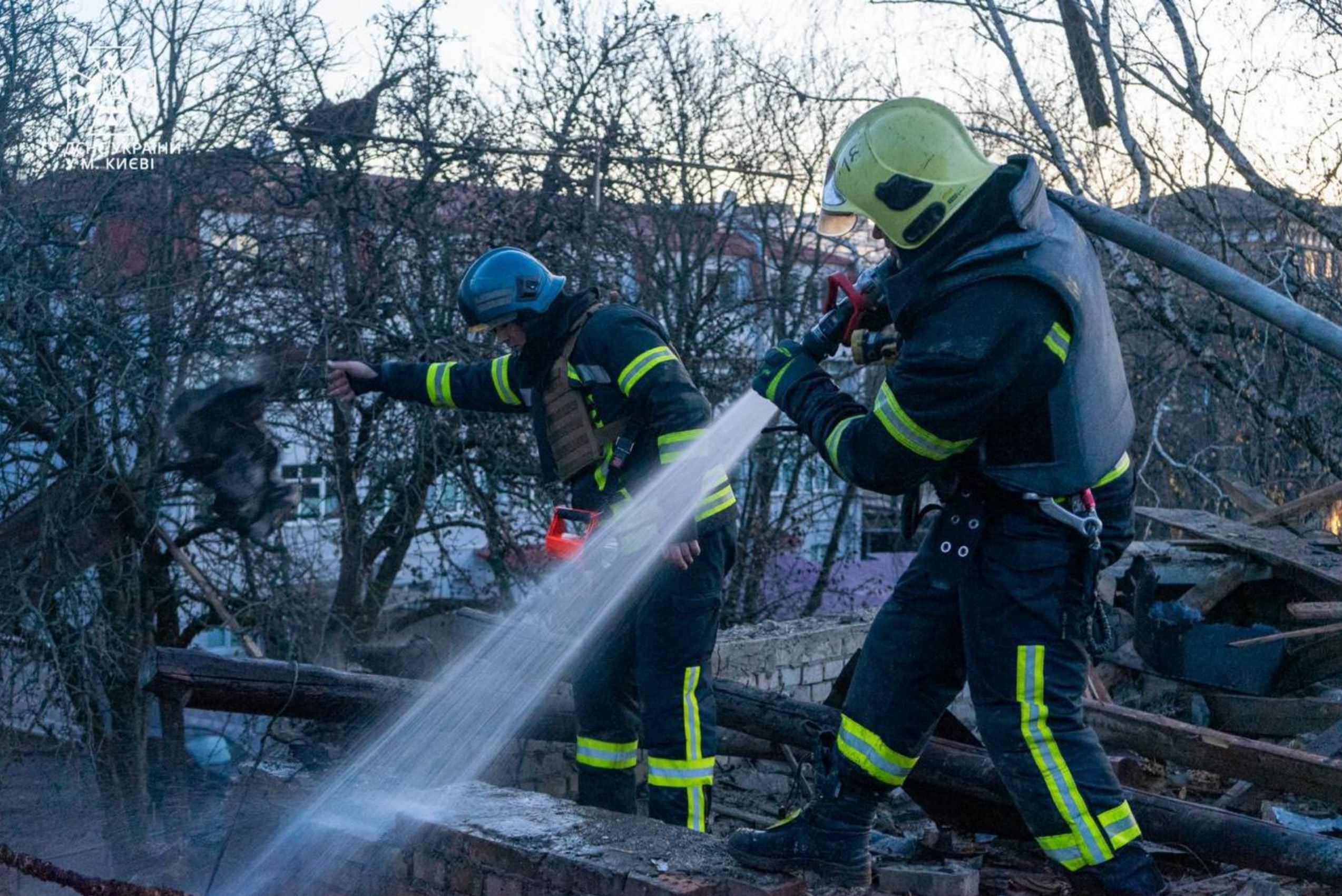 Firemen extinguish a blaze at the site of a Russian drone attack in Kyiv on Saturday
