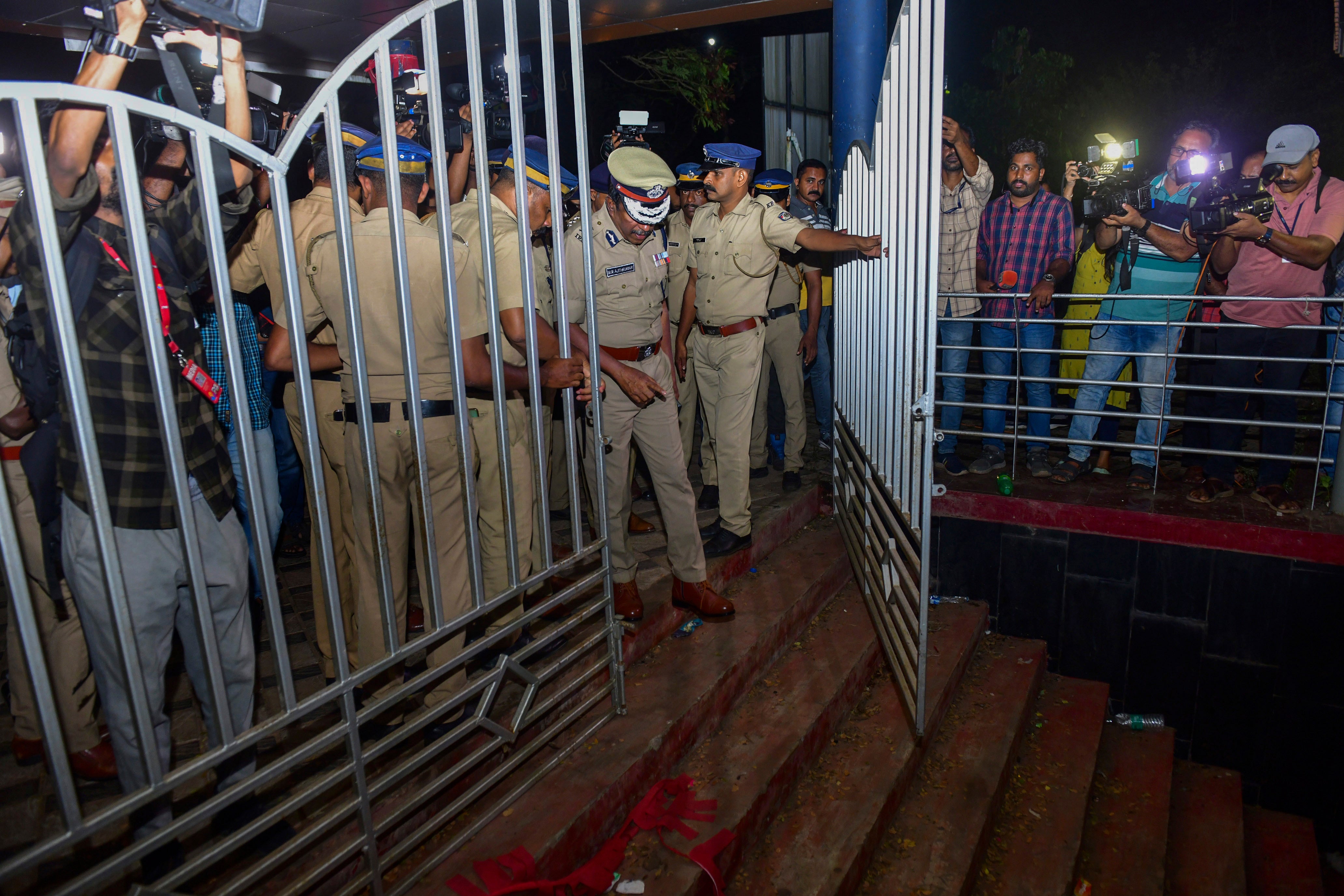 A police officer inspects the spot after a stampede at the venue of a music concert at the Cochin University of Science and Technology in Kochi, Kerala