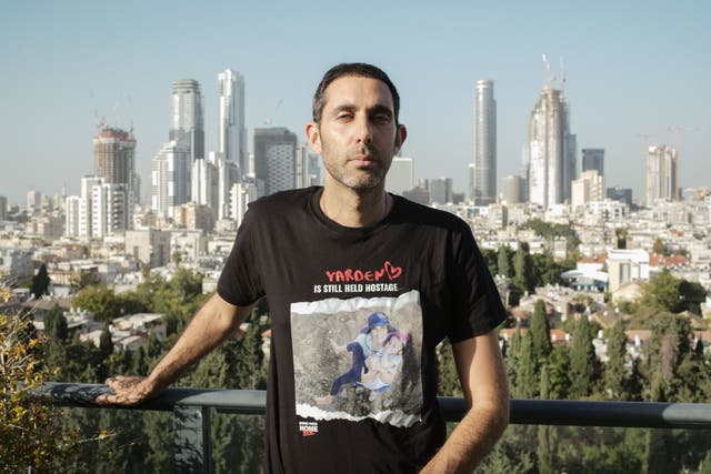 <p>Gili Roman, brother of Yarden Roman-Gat, stands on the balcony of his family’s apartment in Tel Aviv</p>