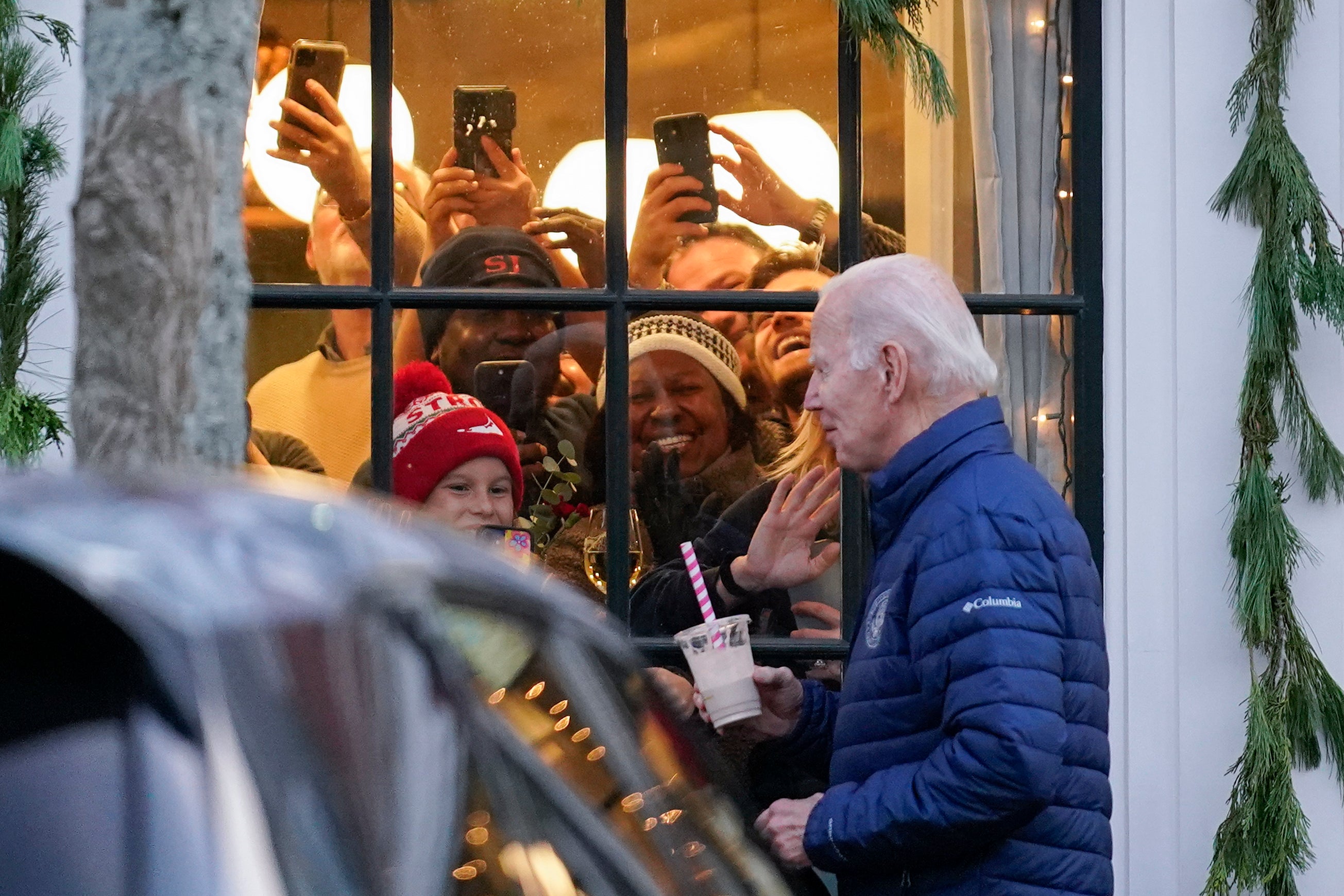 Locals react as Biden walks past while visiting shops with family in Nantucket