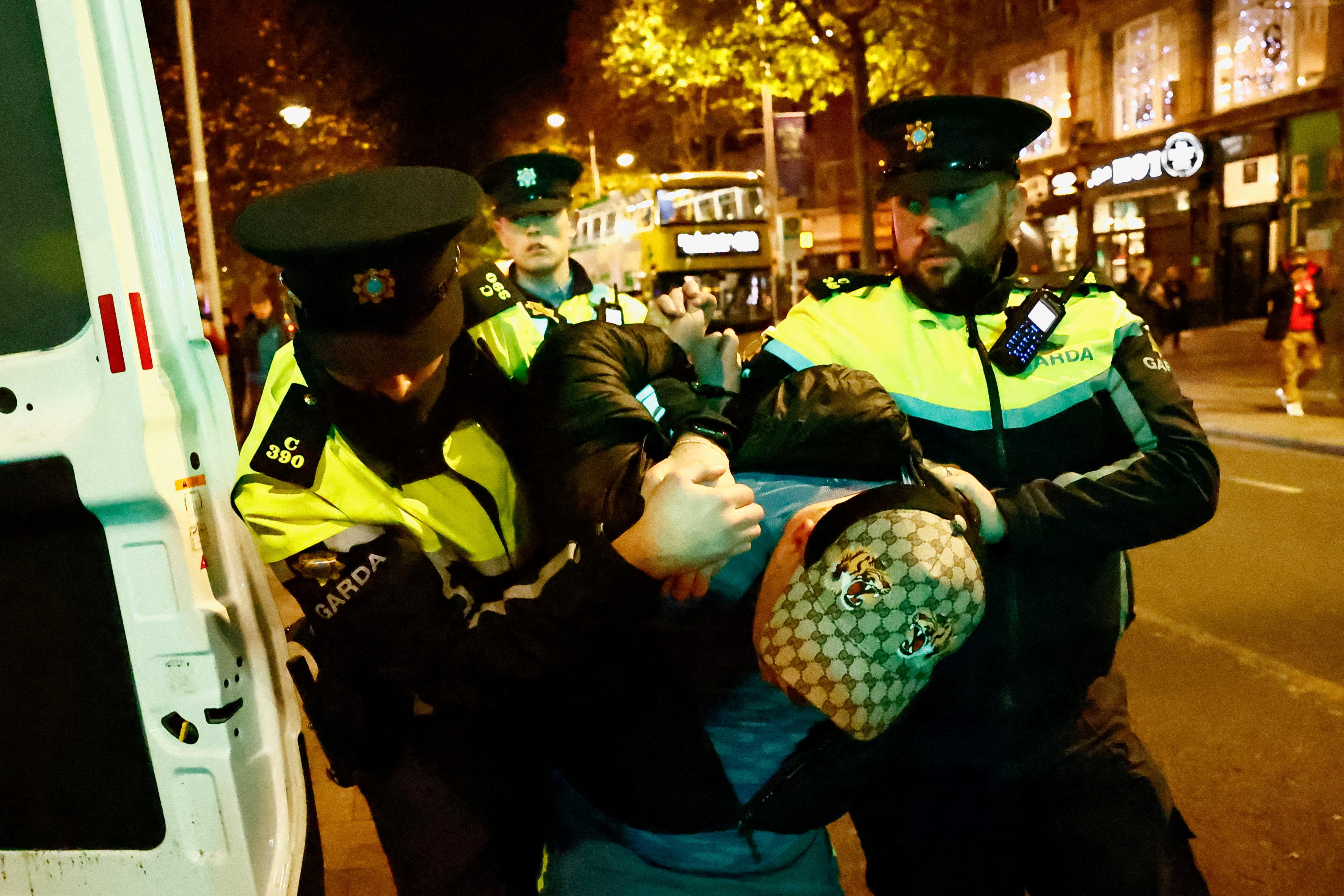 Members of the Garda Public Order Unit detain a man, following the riot in the aftermath of the school stabbing in Dublin
