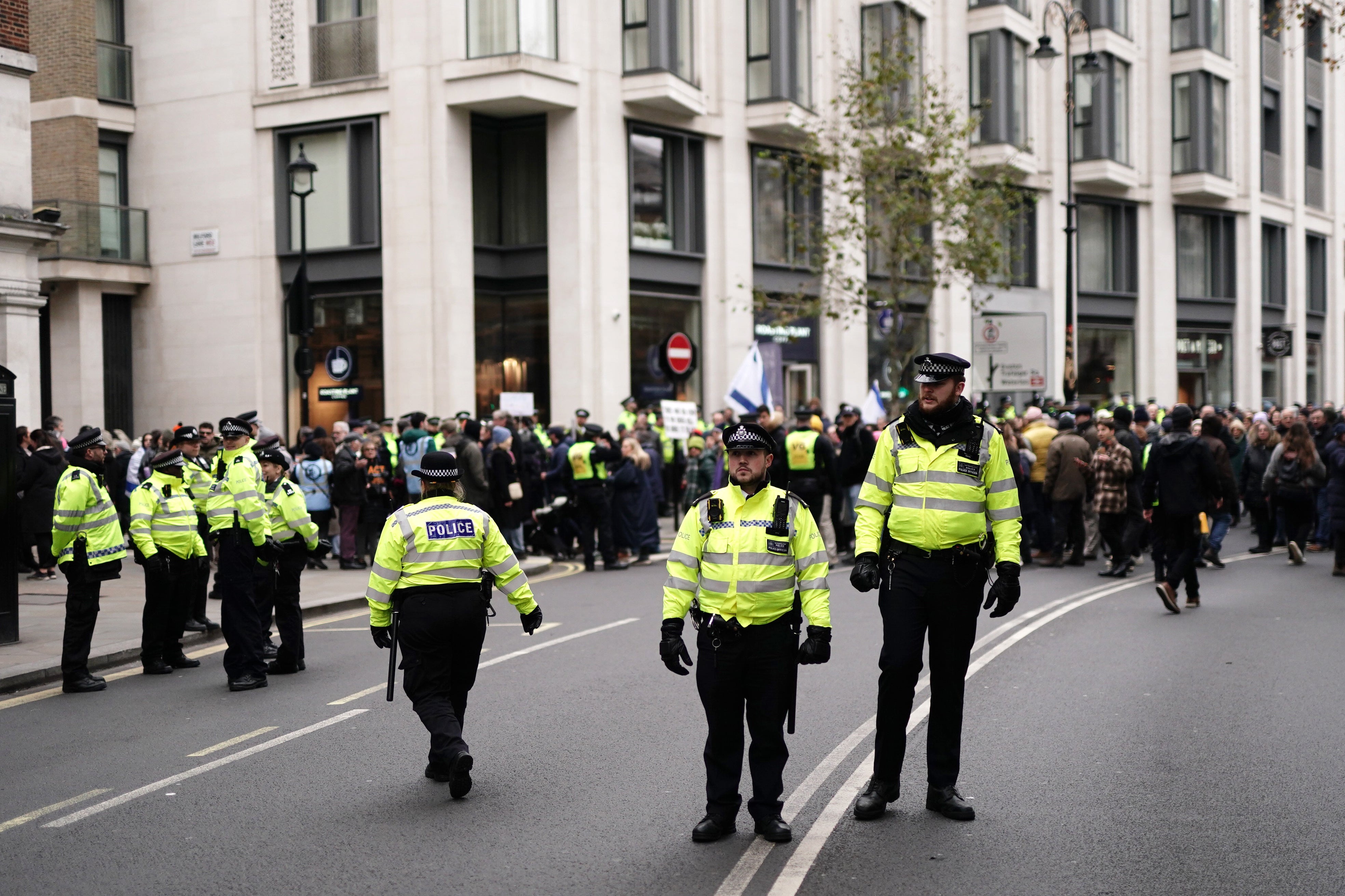 Police officers in attendance as people take part in a march against antisemitism organised by the volunteer-led charity Campaign Against Antisemitism at the Royal Courts of Justice in London