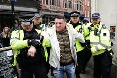 EDL leader Tommy Robinson escorted from antisemitism rally as thousands gather