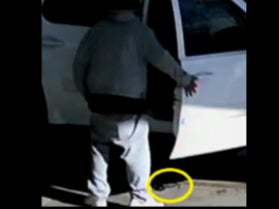 A gun lies at the feet of Avis Damone Coward moments after it accidentally fired and fatally struck a 2-year-old boy inside the car