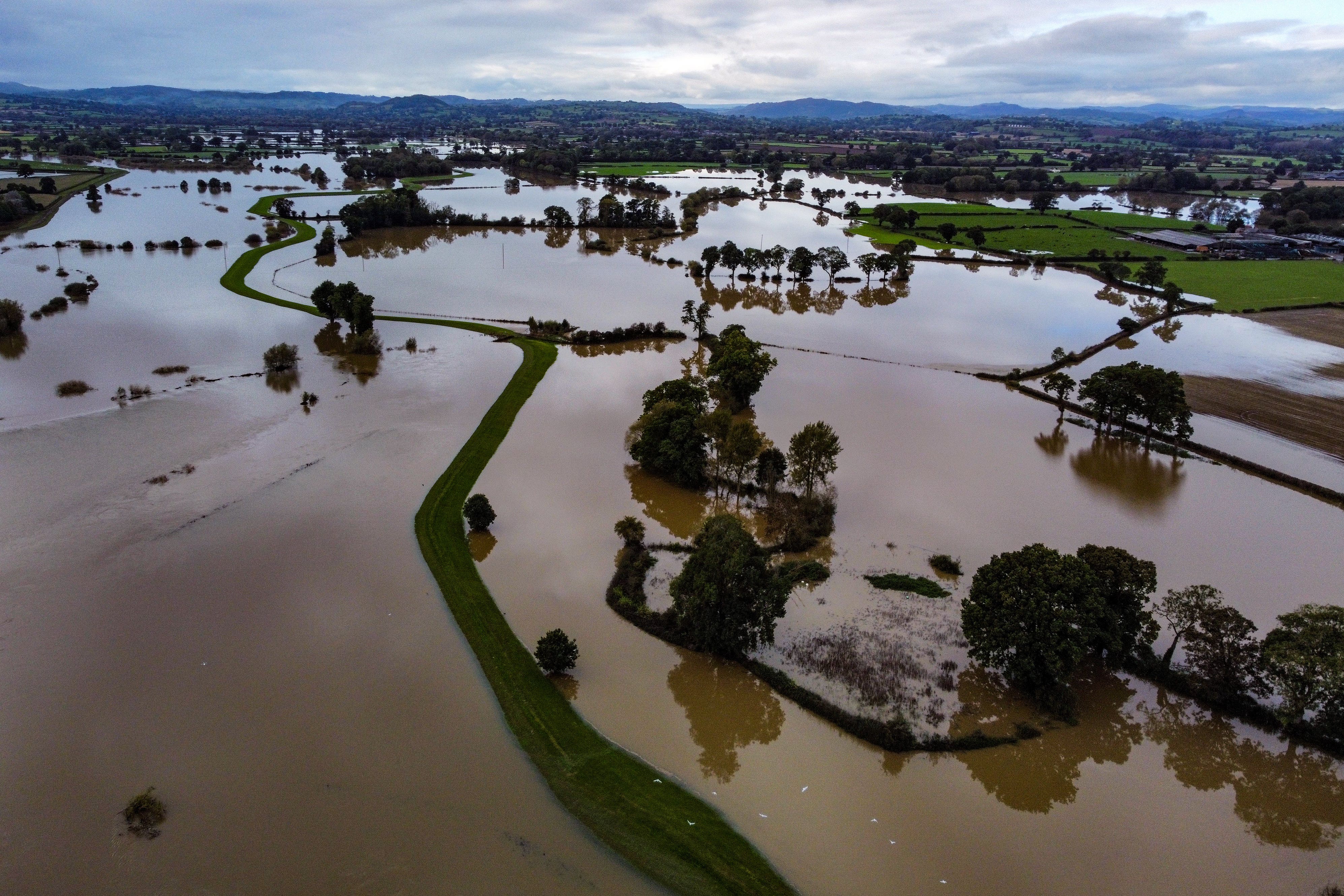 Recent flooding after storms that are becoming more frequent and severe through climate change has ruined UK crops (Ben Birchall/PA)