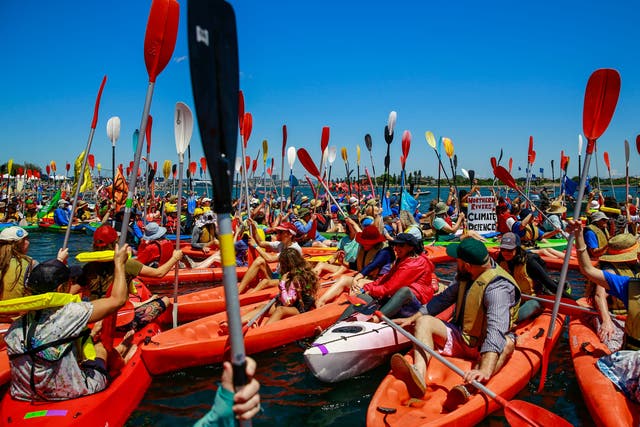 <p>People take to the water as they continue blockade the access to the coal port in protest for climate action at Horseshoe Beach on 26 November 2023 in Newcastle, Australia</p>