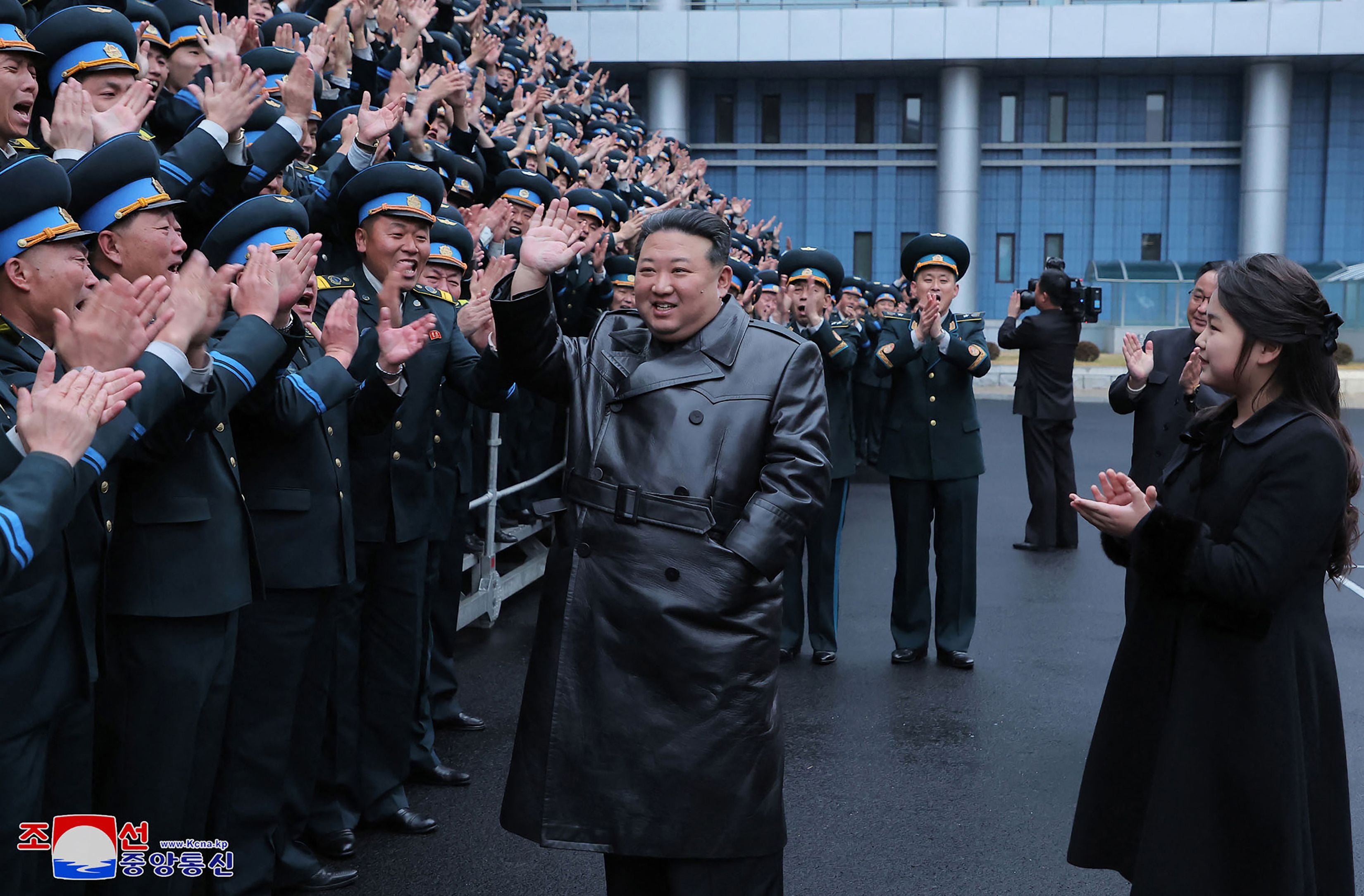 North Korea’s leader Kim Jong-un and his daughter meeting with scientists who contributed to the launch of a reconnaissance satellite