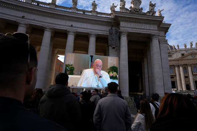 <p>A giant screen broadcasts Pope Francis coughing during the Angelus noon prayer, from the chapel of the hotel at the Vatican grounds where he lives, Sunday, Nov. 26, 2023</p>