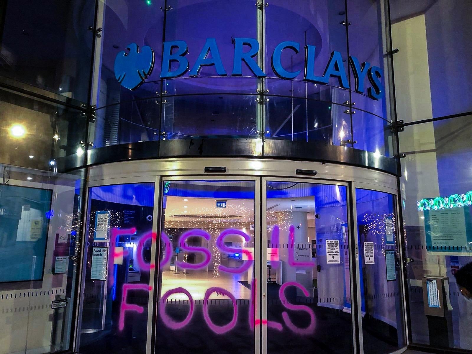 Money Rebellion activists graffitied ‘Fossil Fools’ on the doors of a Barclays branch in Albion Street, Leeds