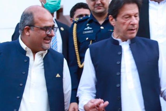 <p>Shahzad Akbar with Imran Khan, before the former government adviser fled Pakistan for the UK </p>