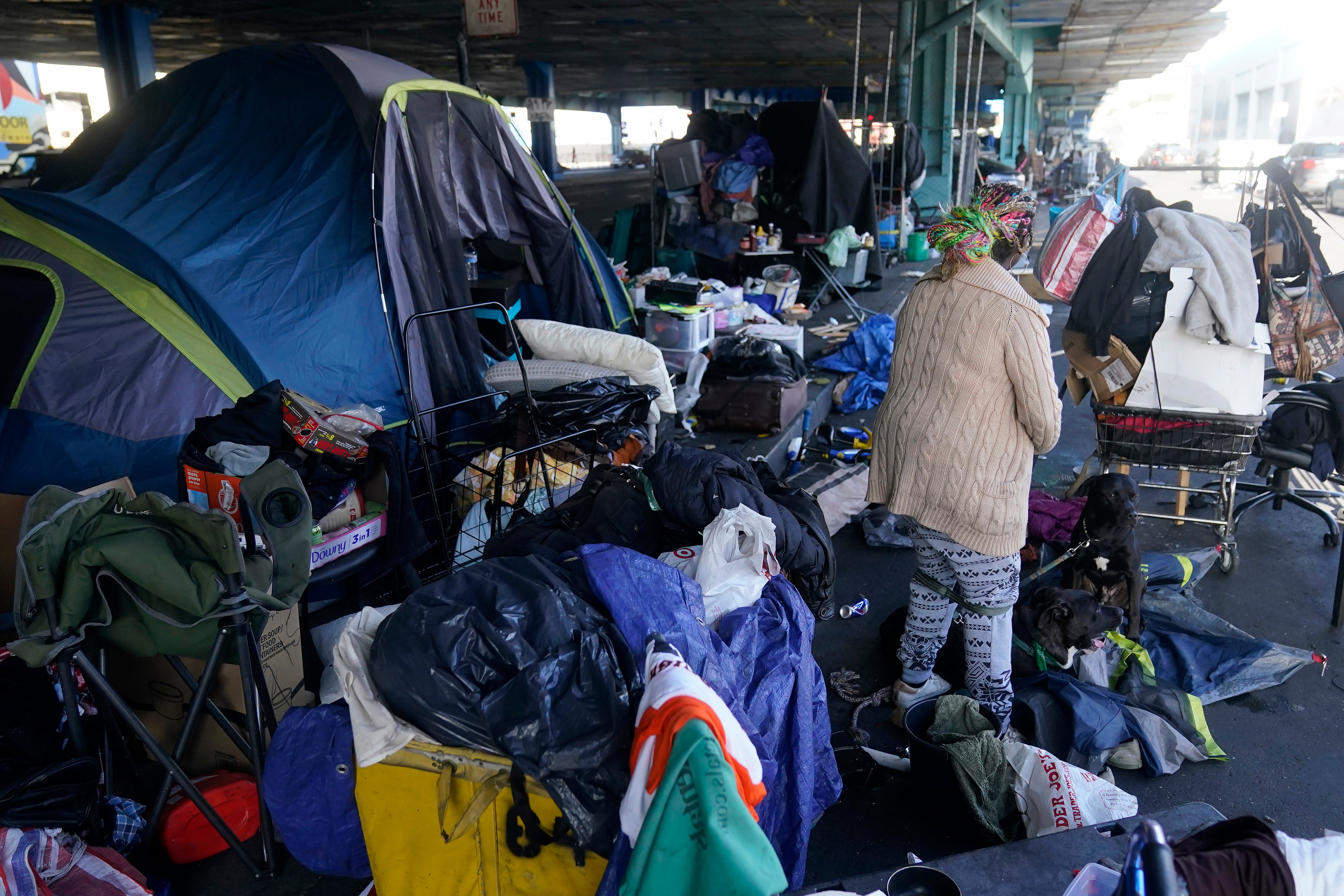 <p>A woman gathers possessions to take before a homeless encampment was swept in San Francisco in 2023. A former journalist chronicled his life being homeless in a viral piece for <em>Esquire </em></p>