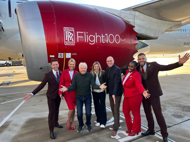 <p>Taking off: Sir Richard Branson (third from left) and his Virgin Atlantic team beside the Boeing 787 used for the first SAF transatlantic flight</p>