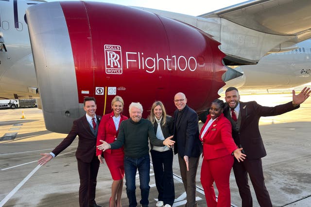 <p>Taking off: Sir Richard Branson (third from left) and his Virgin Atlantic team beside the Boeing 787 used for the first SAF transatlantic flight</p>