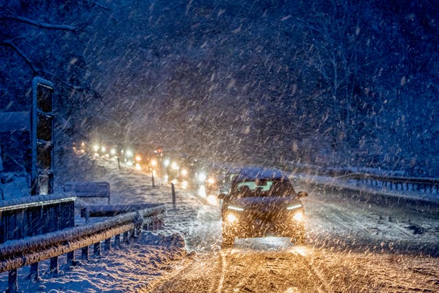<p>Commuters queue in heavy snowfalls on a country road in a forest of the Taunus region near Frankfurt, Germany, early Tuesday, Nov 28</p>
