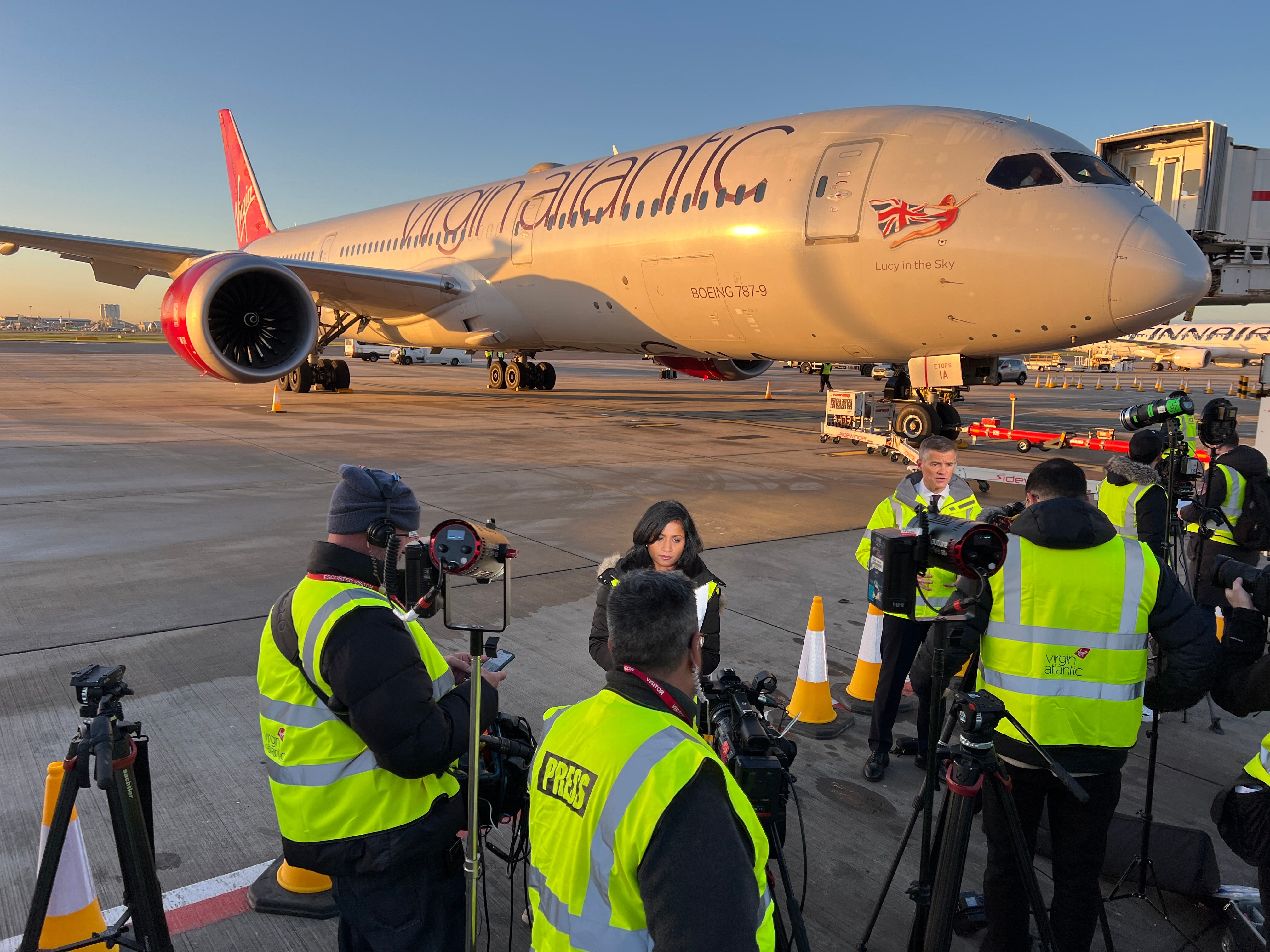 Media scrum: Journalists ahead of the departure of Flight100 to New York