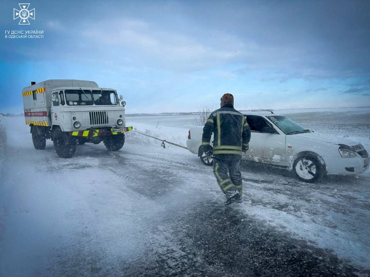 Emergency workers release a car stuck in snow in the Odesa region of Ukraine on Tuesday