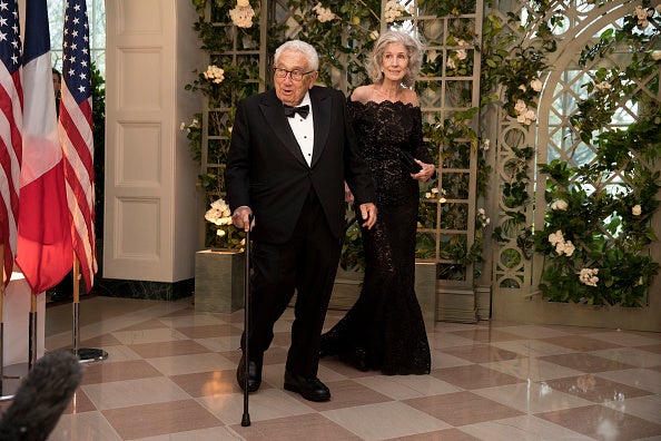 Kissinger and his wife Nancy arrive at the White House for a state dinner on 24 April 2018