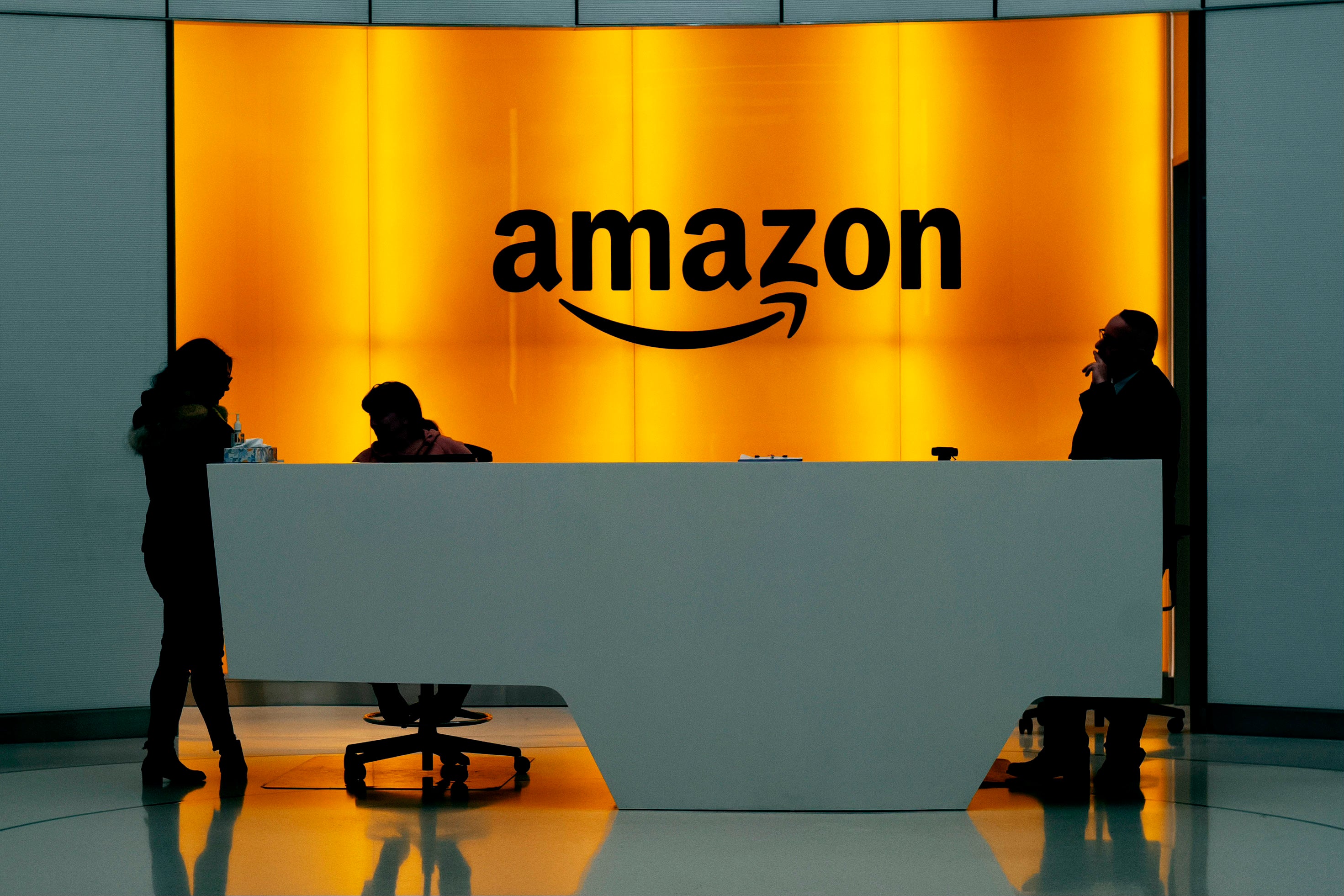 People stand in the lobby for Amazon offices in New York