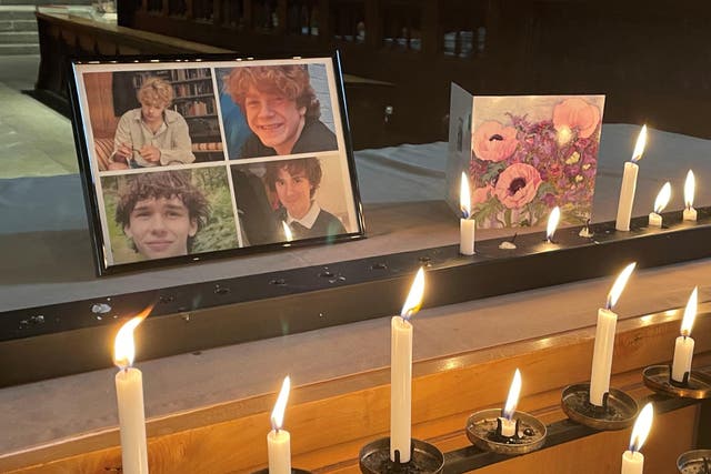 Photographs of Jevon Hirst, Harvey Owen, Wilf Fitchett and Hugo Morris inside Shrewsbury Abbey, where people paid their respects (PA)