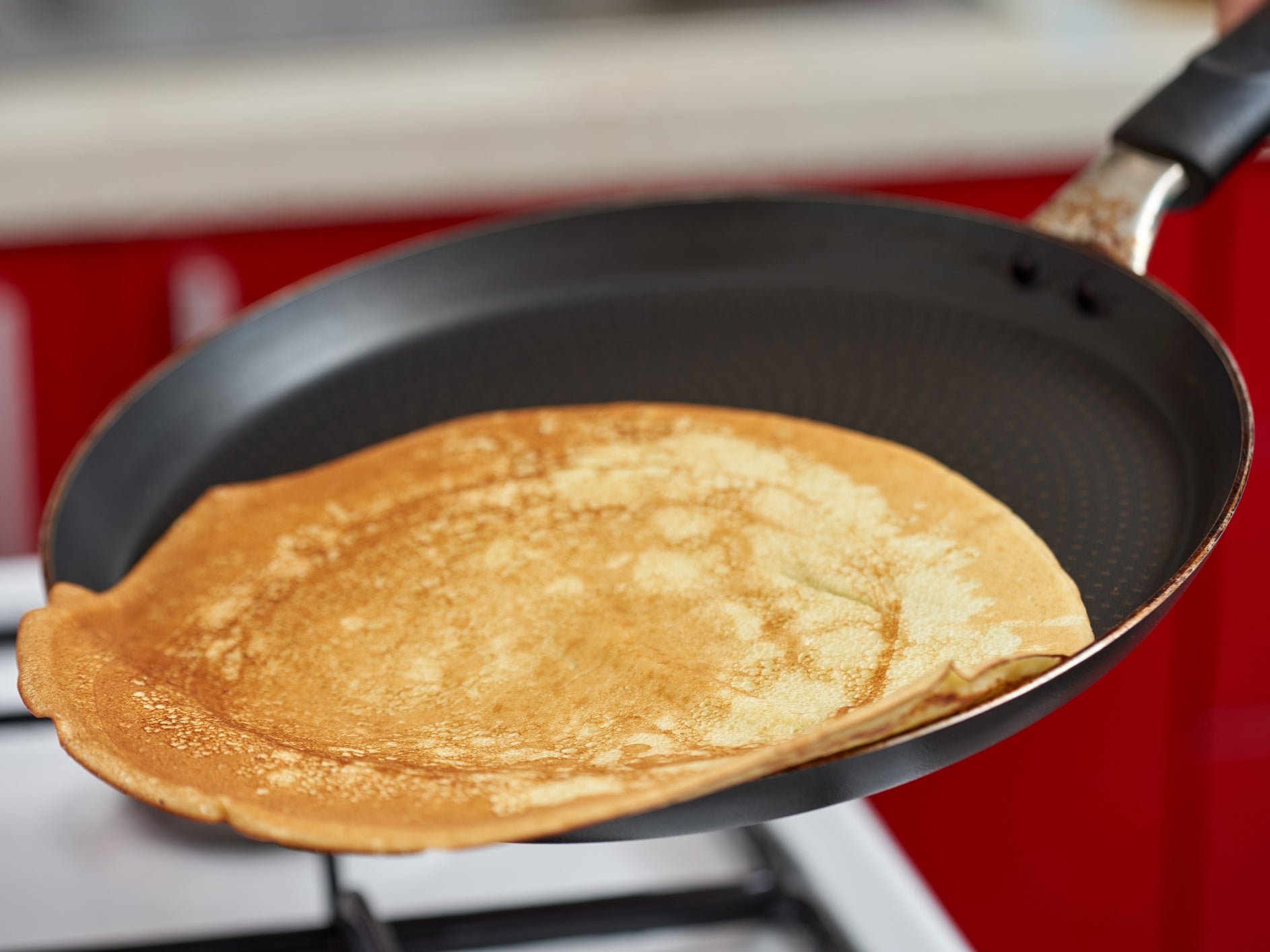A pancake being flipped on Shrove Tuesday - the day before Valentine’s Day