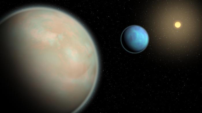 An illustration of two water-rich exoplanets with hazy atmospheres.