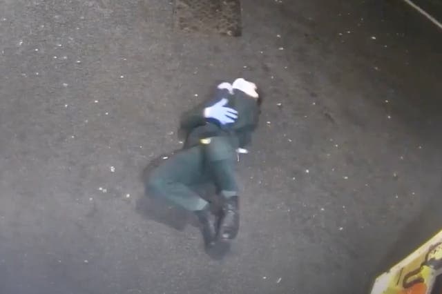 <p>Paramedic clutches his elbow after the fall </p>