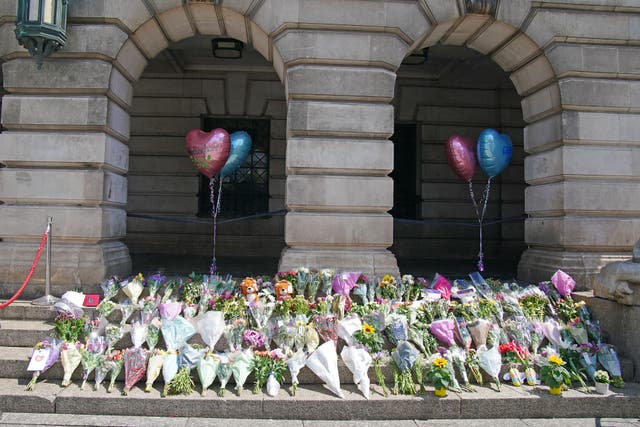 Flowers and tributes on the steps of Nottingham Council House after three people were killed and another three hurt in the city (Peter Byrne/PA)