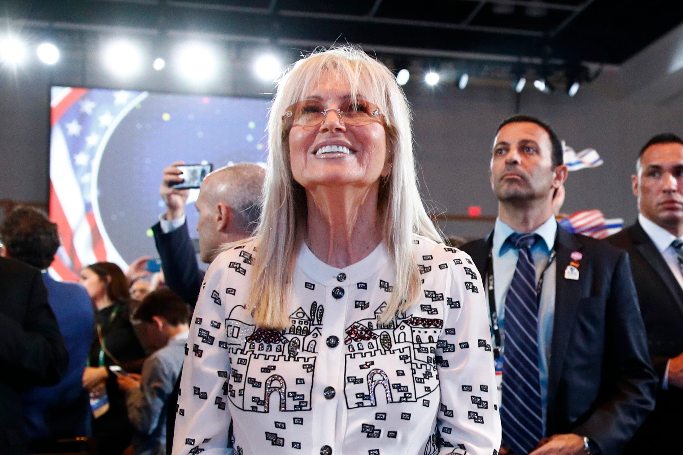 Miriam Adelson listens as Trump addresses an Israeli American Council summit in Hollywood in 2019