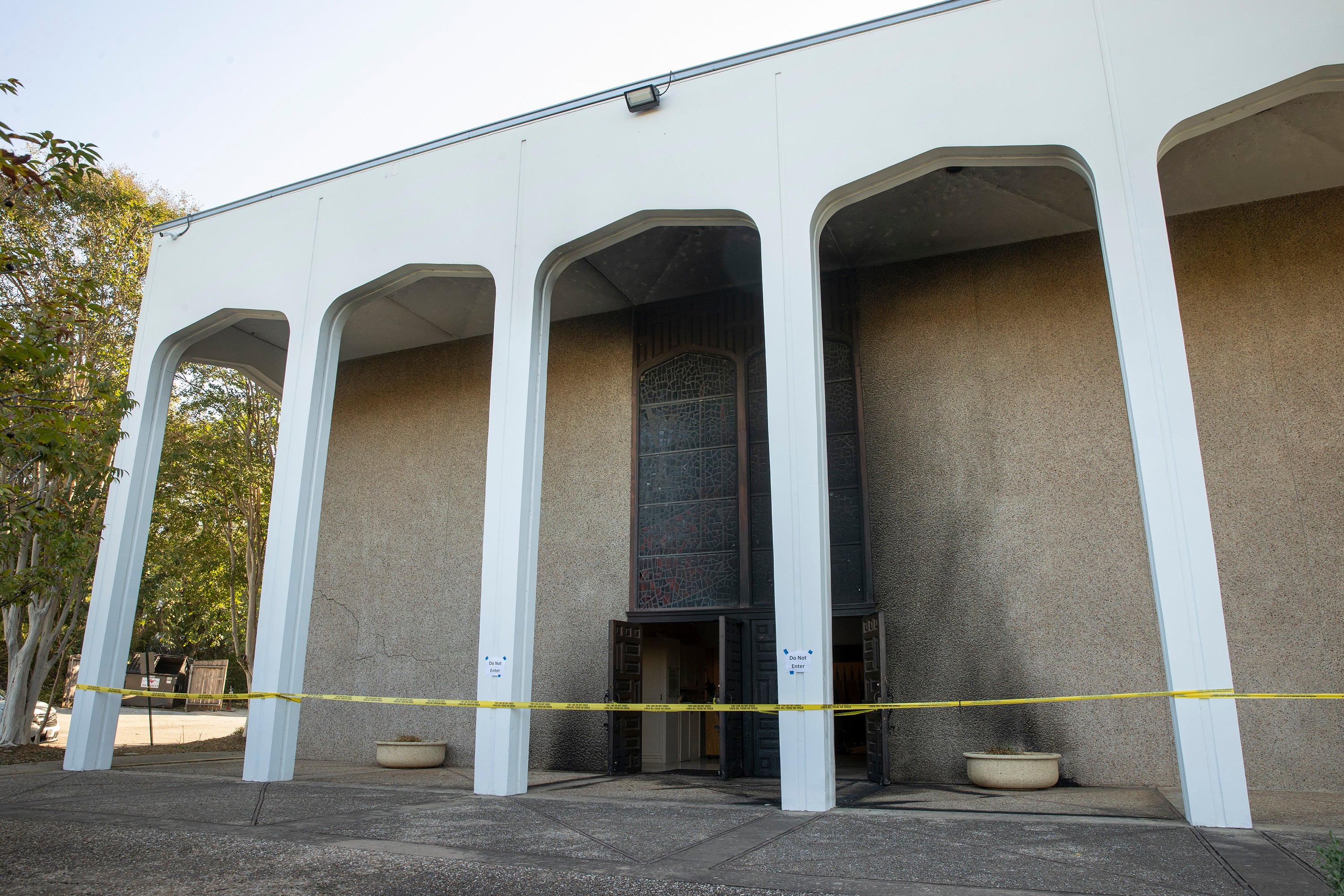 Caution tape marks the front doors at Congregation Beth Israel on 1 November 2021, after fire at the synagogue in Austin, Texas, the previous day.