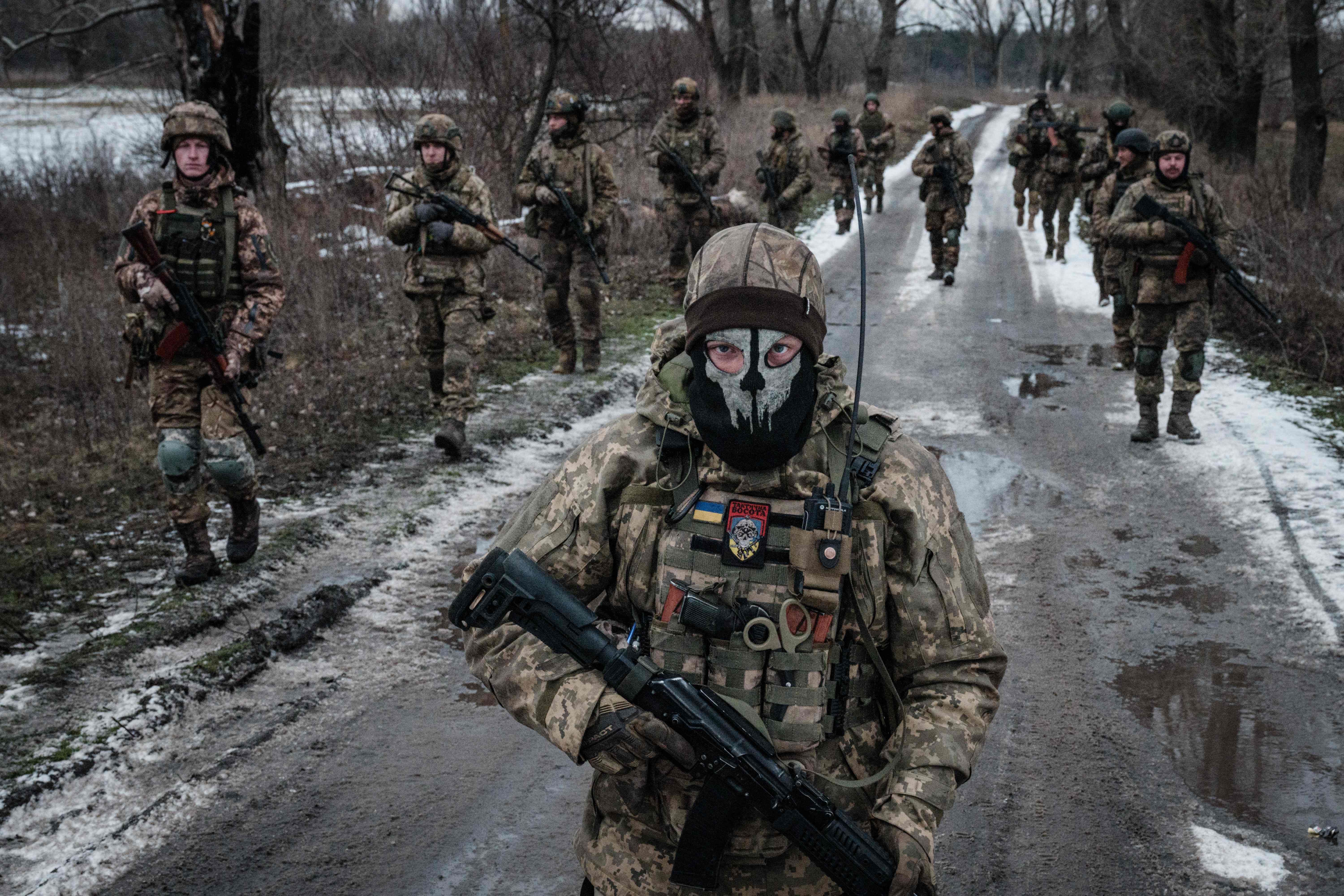 <p>krainian servicemen walk on the road toward their base near the frontline in the Donetsk region on 4 February</p>