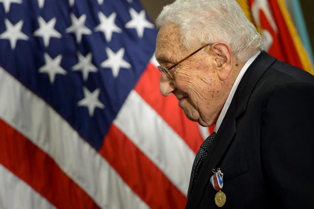 <p>Former US Secretary of State Henry Kissinger smiles after receiving an award during a ceremony at the Pentagon </p>