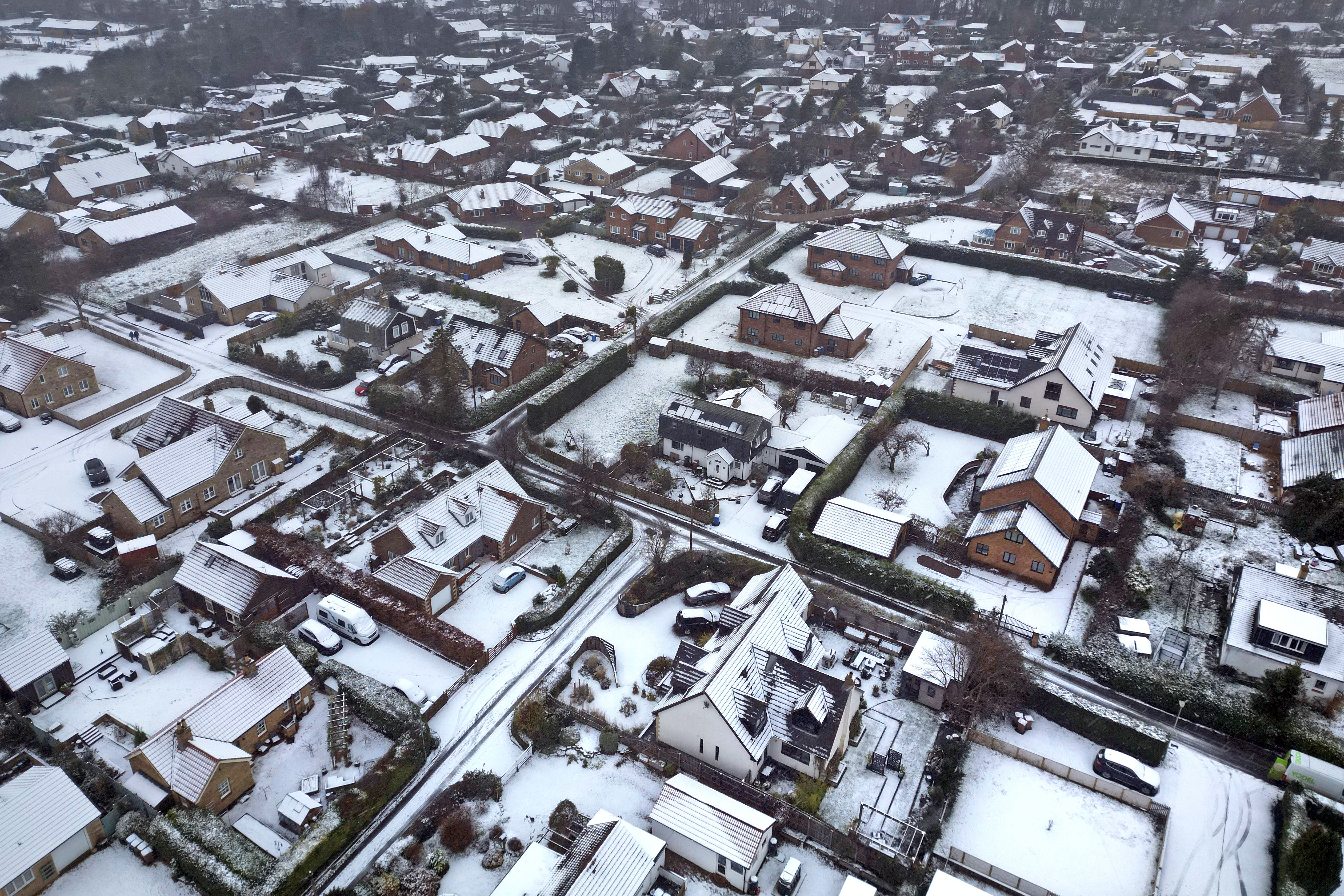 Schools closed and crashes reported as snow sweeps across parts of