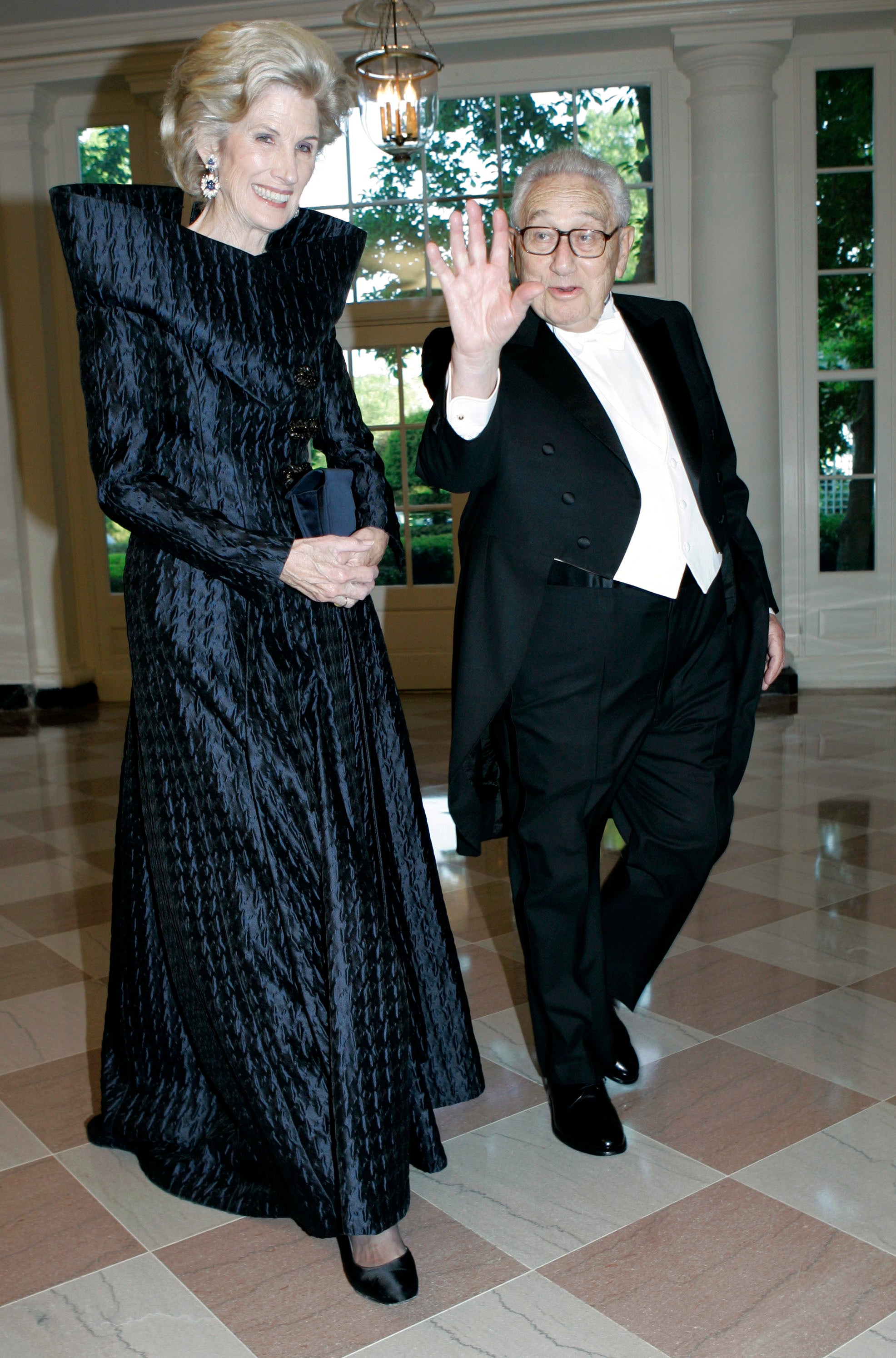 Henry Kissinger, right, and his wife Nancy walk through the Booksellers Area as they arrive for the State Dinner in honor of Queen Elizabeth II and her husband Prince Philip, May 7, 2007, at the White House in Washington.
