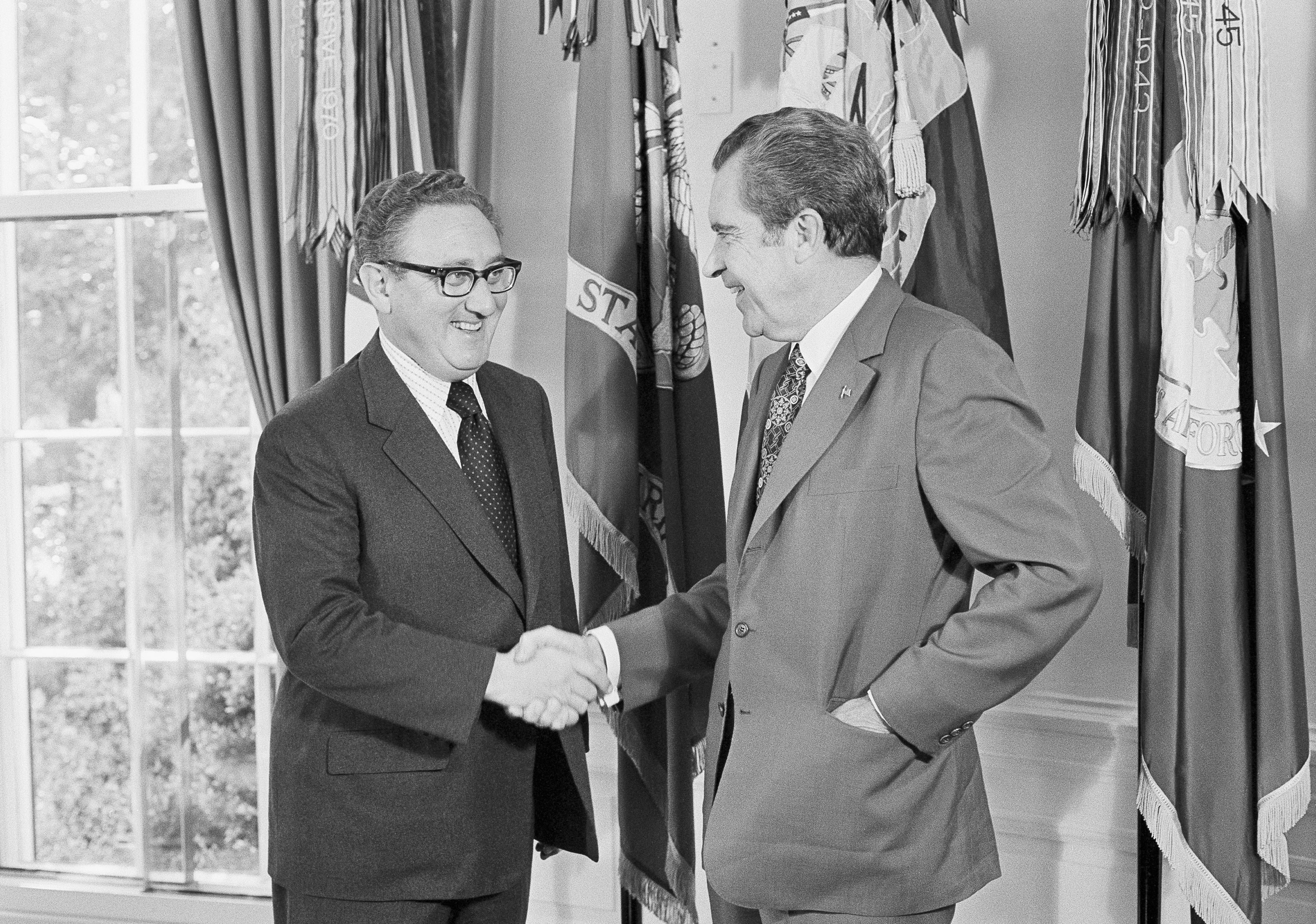 <p>President Richard Nixon, right, offers his congratulations to his Secretary of State Henry Kissinger, after he was awarded the Nobel Peace Prize in 1973 </p>