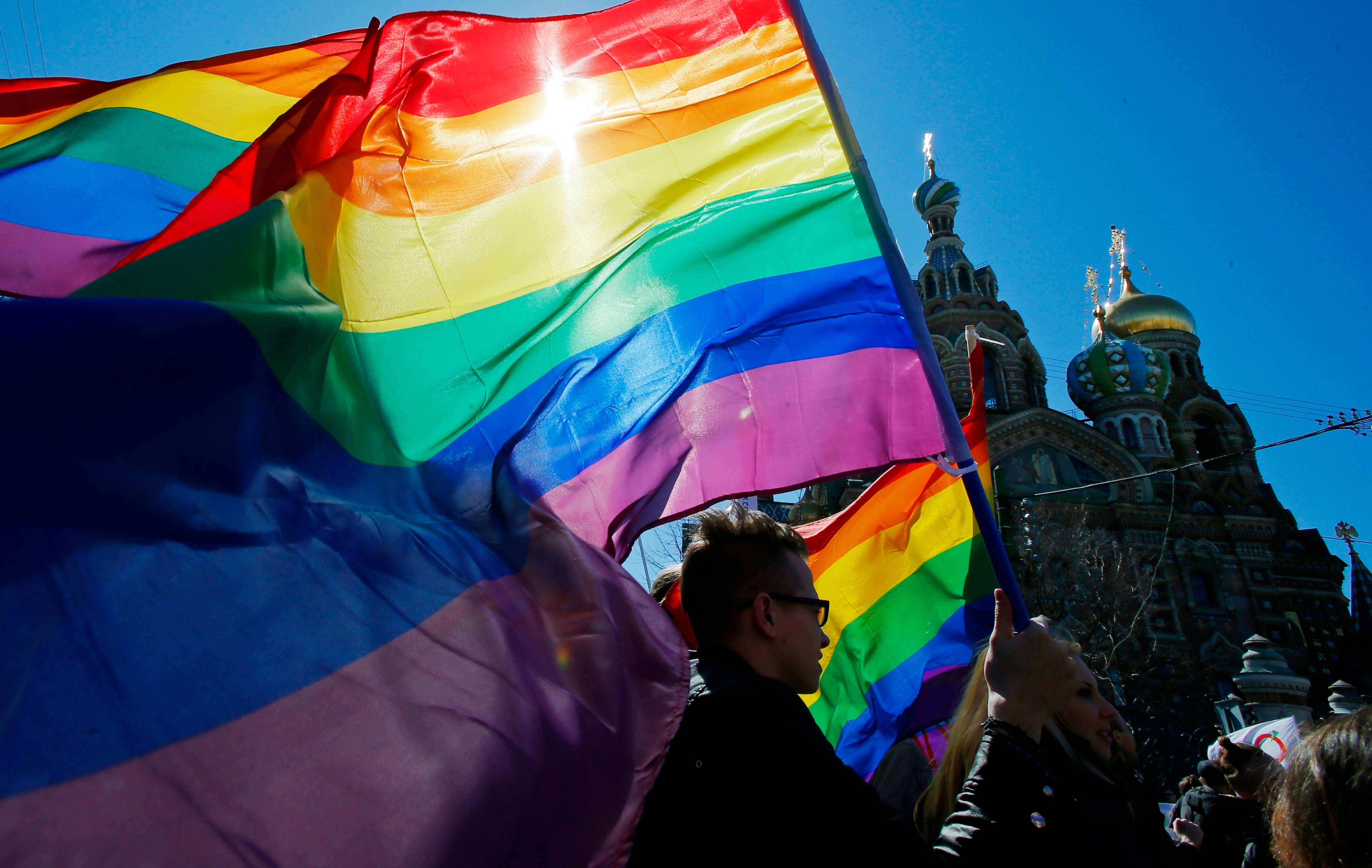 Gay rights activists carry rainbow flags as they march during a May Day rally in St. Petersburg, Russia (File photo).