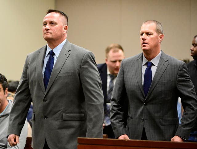 <p>FILE - Paramedics Jeremy Cooper, left, and Peter Cichuniec, right, attend an arraignment at the Adams County Justice Center in Brighton, Colo., on Jan. 20, 2023. </p>