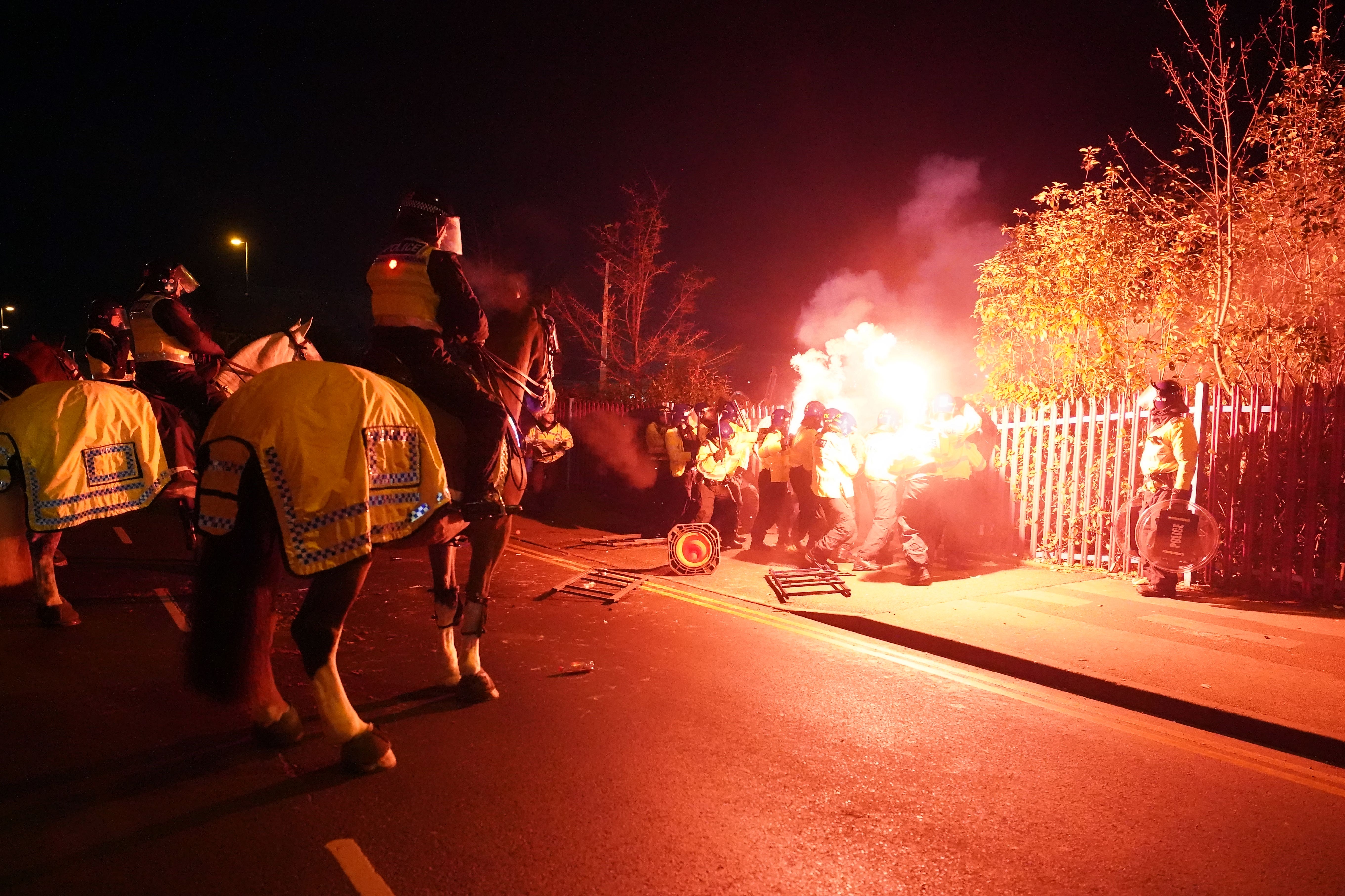 Police attempt to put out flares that have been thrown towards them outside the stadium before the UEFA Europa Conference League Group E match at Villa Park, Birmingham (David Davies/PA)